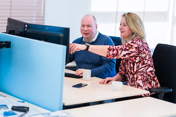 Colleagues behind laptop